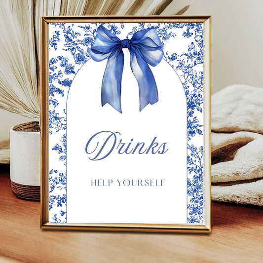 Decorative sign with Royal blue bow and floral design on a wooden surface