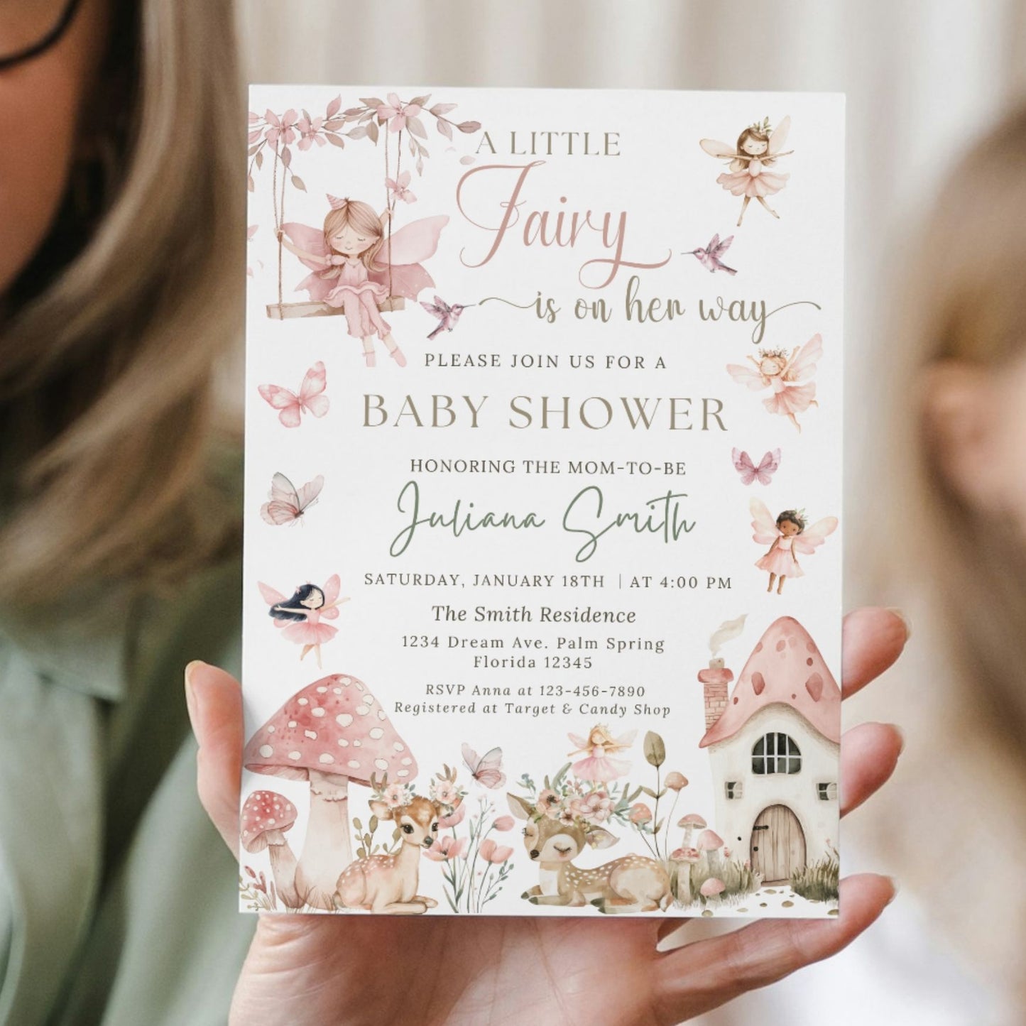 Baby shower Girl invitation with fairy theme held by a person