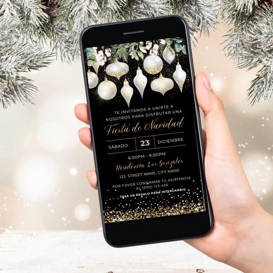 Hand holding a smartphone with a White and Gold Christmas invitation on the screen, surrounded by festive decorations.