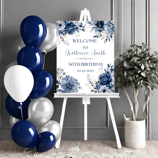 Birthday welcome sign with blue and white balloons and a plant on a gray wall background