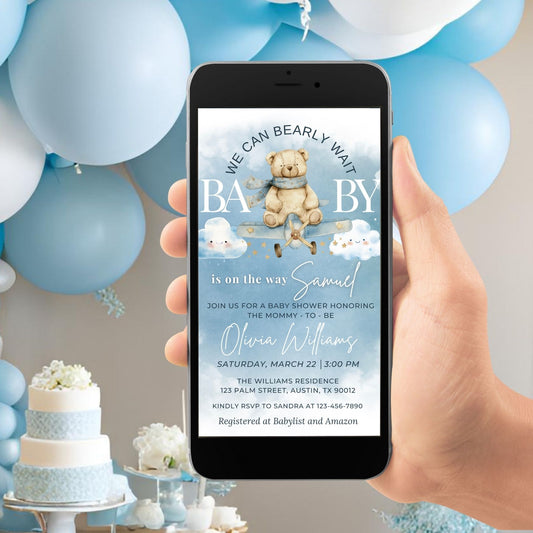 Electronic baby shower invitation with cute bear pilot design, personalized for baby boy, set against blue balloon decor.