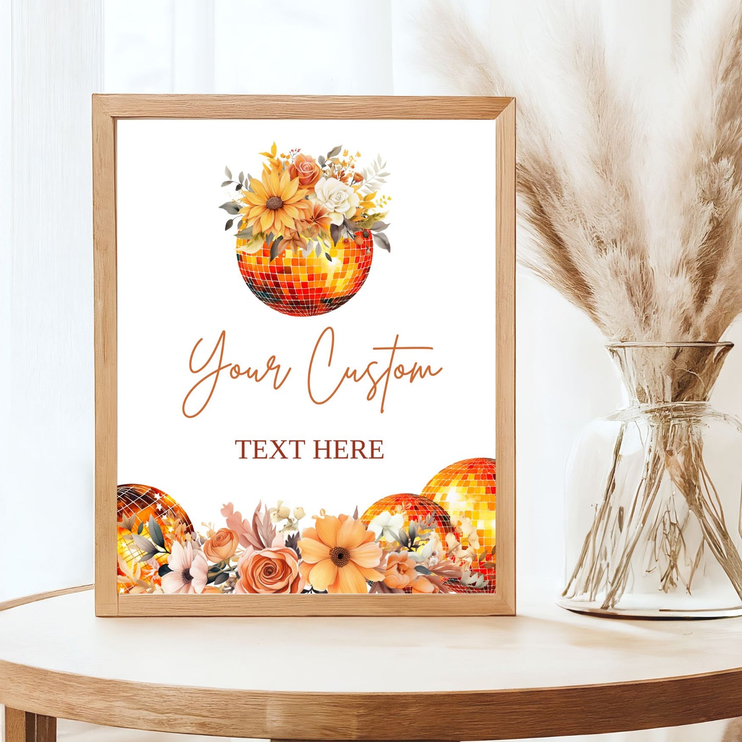 Framed artwork with floral Fall and orange disco ball design and customizable text on a table.