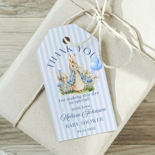 Gift tag with a baby shower theme on a wrapped gift box.