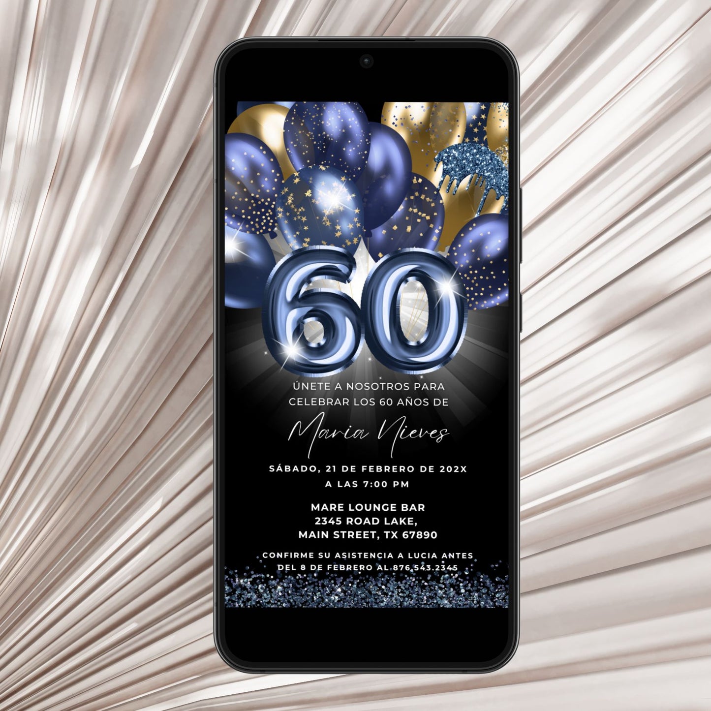 Phone displaying a birthday invitation with blue balloons and number '60' on a textured surface