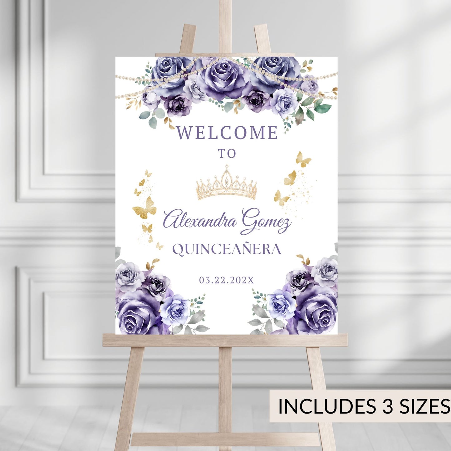 Quinceanera welcome sign with purple flowers and a crown on a wooden stand against a gray wall.