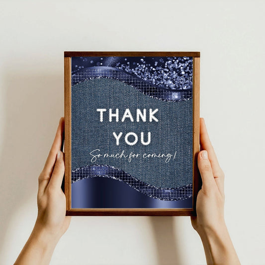 Framed sign with denim and white 'THANK YOU So much for coming!' text held by hands against a light background