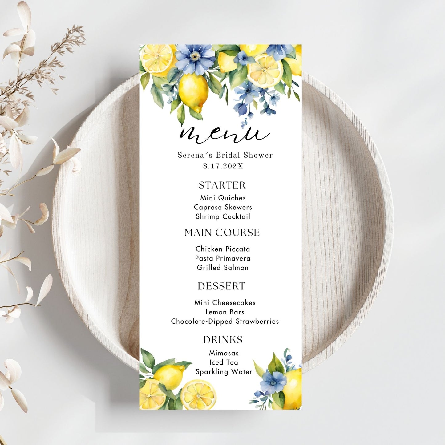 Menu card for a bridal shower with Blue floral and lemon design on a white plate.