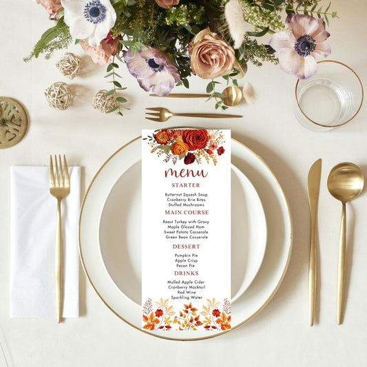 Table setting with floral arrangement, menu card, and cutlery on a white tablecloth.