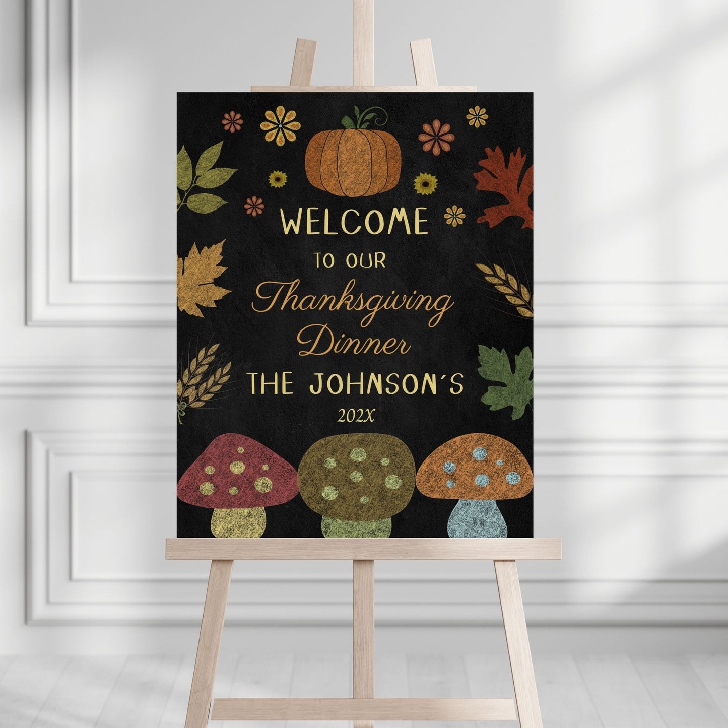 Thanksgiving dinner welcome sign with pumpkins, leaves, and mushrooms on a black background.