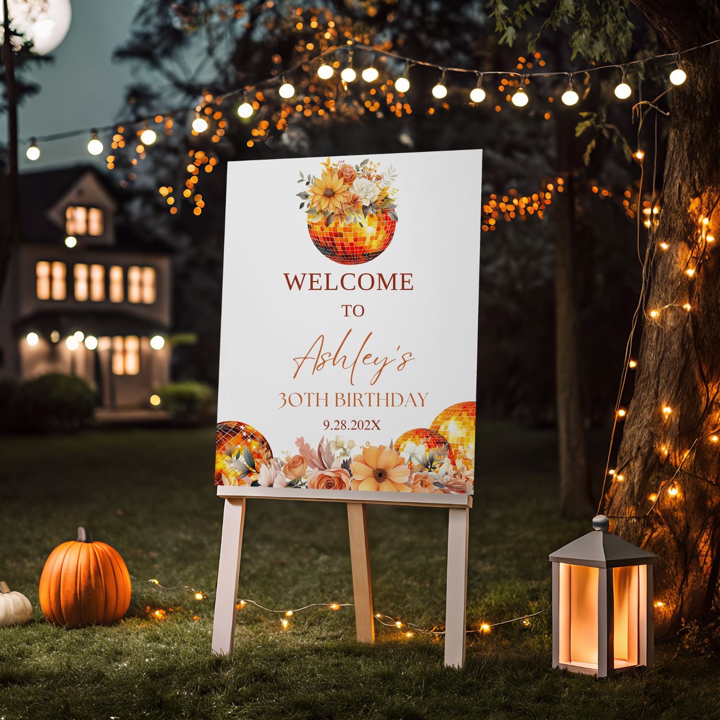 Decorative Floral Disco ball birthday welcome sign with pumpkins in a garden setting with string lights.