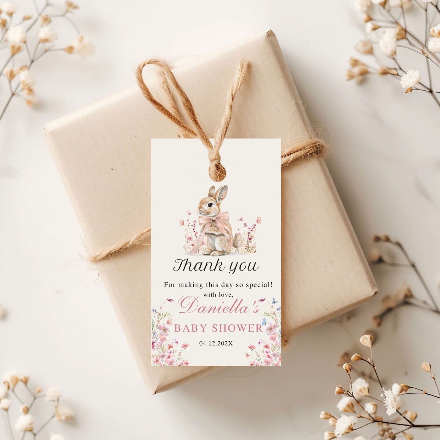 Gift box with a decorative Thank you tag for a baby shower on a light background