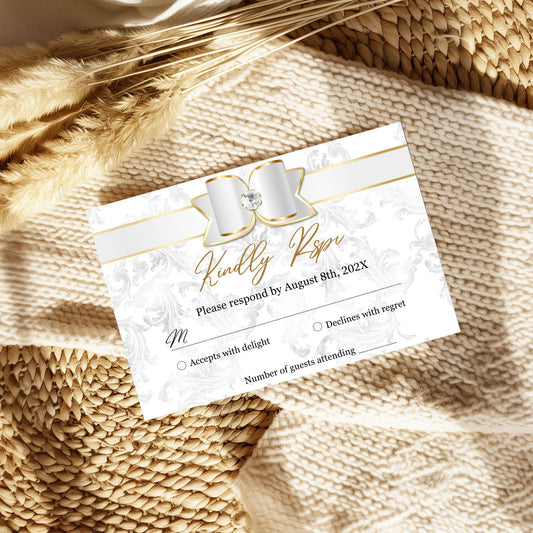 Elegant Wedding RSVP card with marble design and gold accents on a textured beige surface.