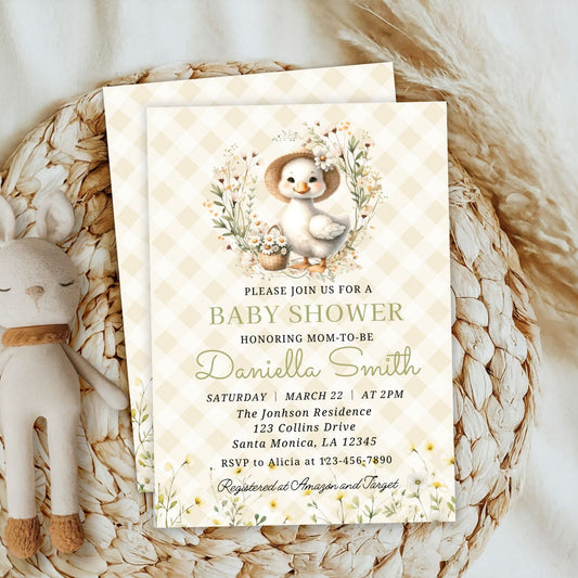 Baby shower invitation with a baby duck design on a woven surface