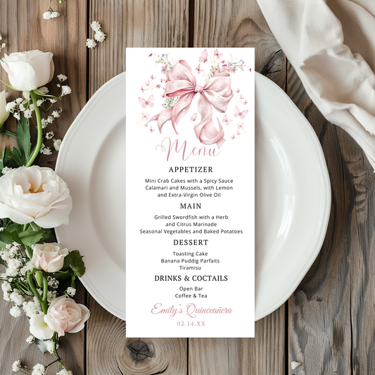 Menu card with Pink Bow Pearls floral design on a wooden table with flowers and a plate.