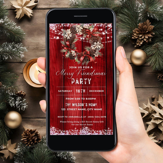 Hand holding a phone displaying a digital Christmas party invitation on a festive background with decorations.
