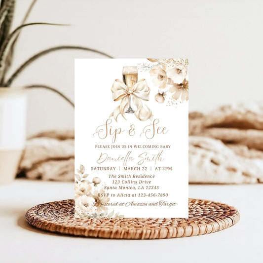 Baby shower invitation with champagne glass and elegant bow on a decorative plate