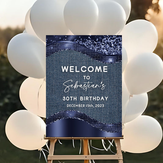 Birthday welcome sign on an easel with white balloons in the background