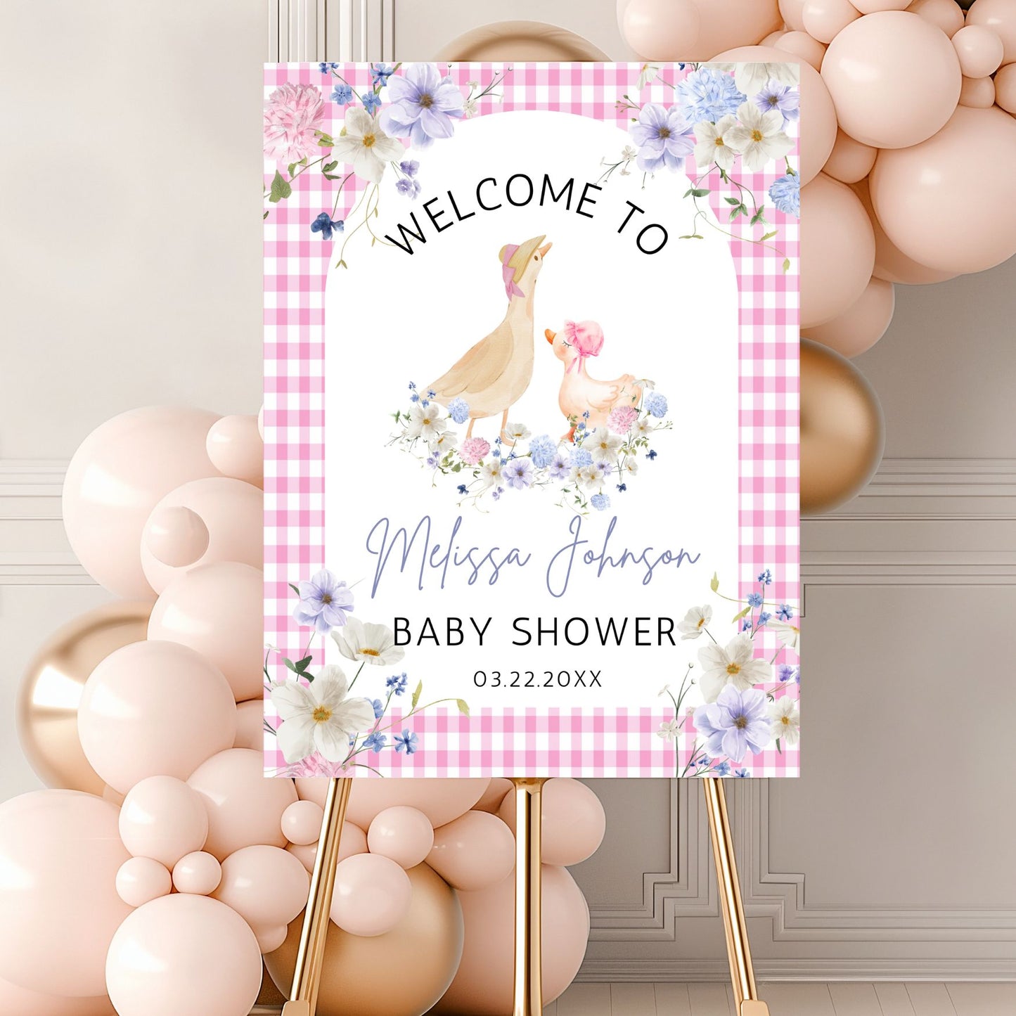Baby shower welcome sign with chickens and flowers on a pink checkered background, surrounded by balloons.