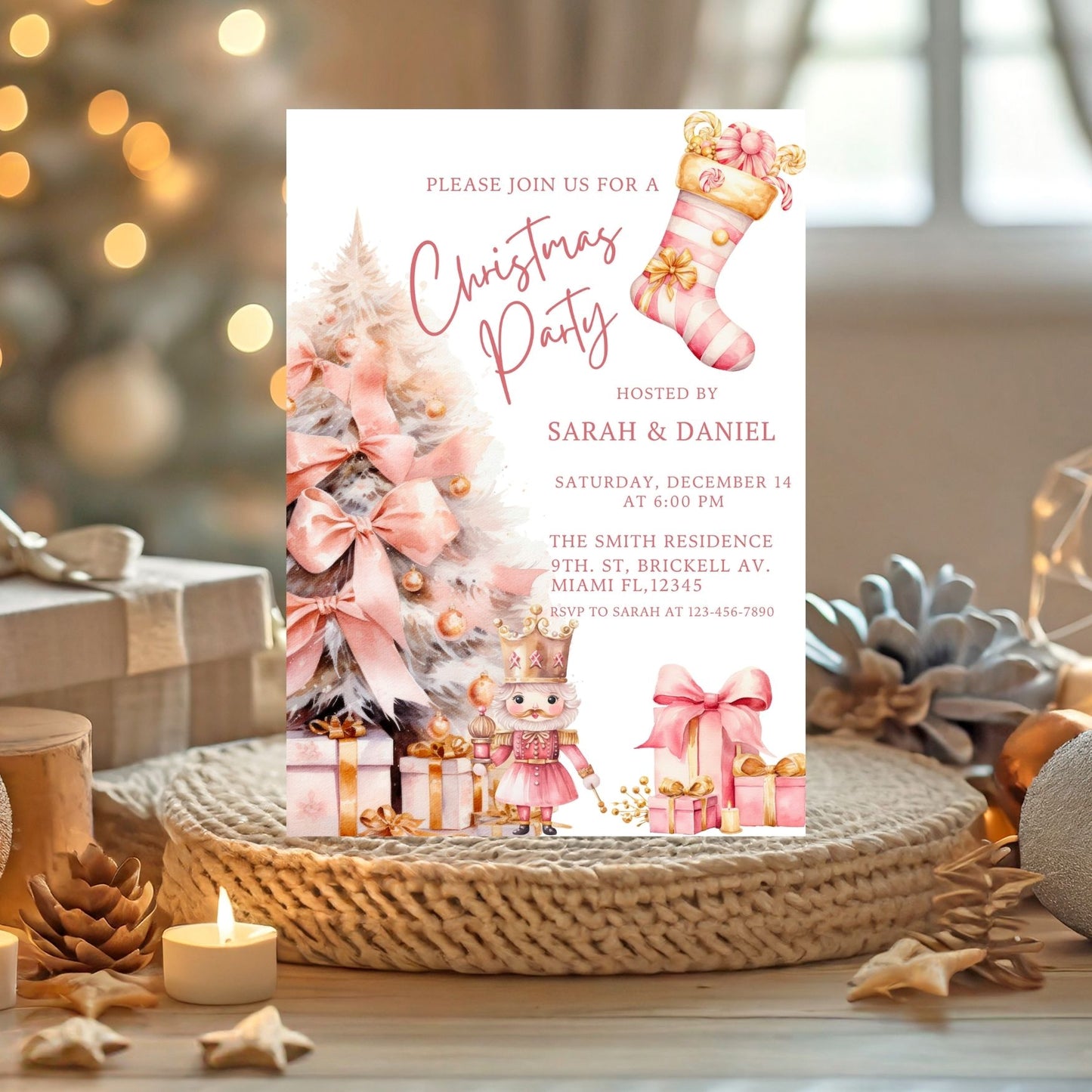 Pink Christmas party invitation card with festive design on a decorative table.
