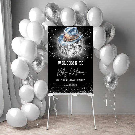 Party welcome sign with disco ball and cowboy hat design, surrounded by white and silver balloons.