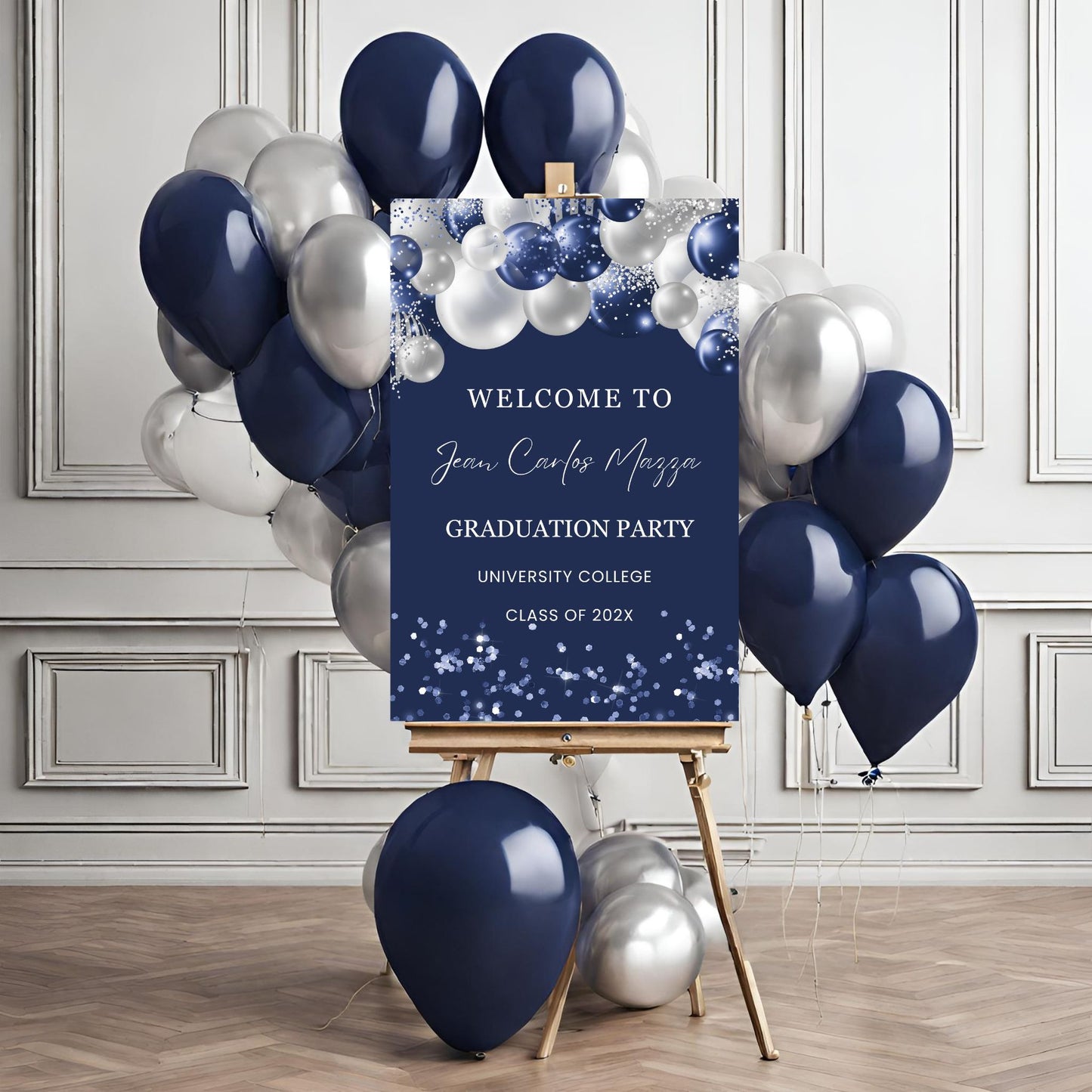 Graduation party welcome sign with navy and silver balloons on a wooden floor.