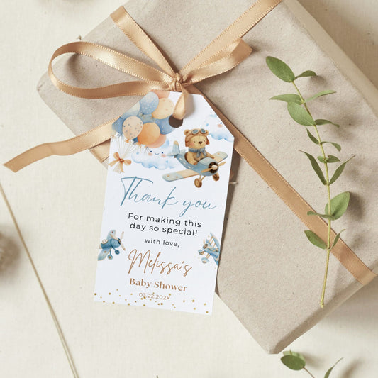 Gift box with a decorative tag for a baby shower on a light background