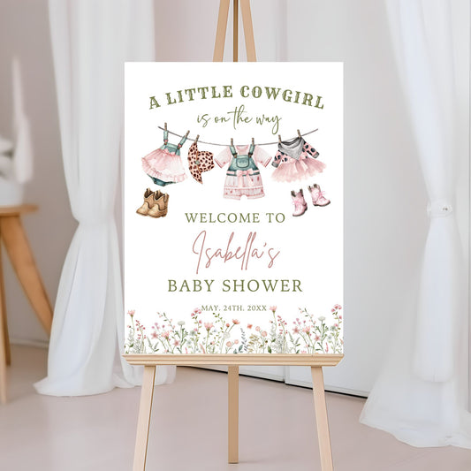 Baby shower sign with cowgirl theme on an easel
