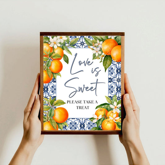 Framed artwork Mediterranean Blue Tile with oranges and floral design held by hands against a light background, Text: Love is Sweet