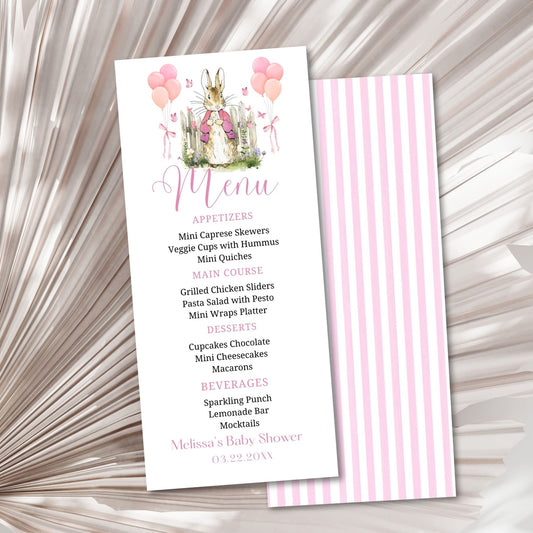 Menu card for a baby shower with a rabbit illustration on a textured surface