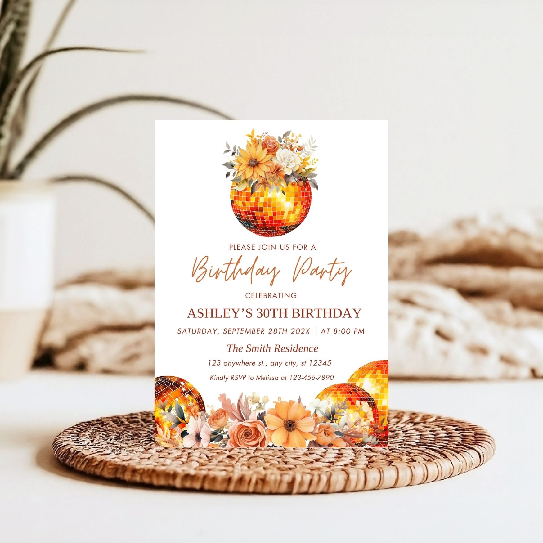 Floral Disco Ball Birthday party invitation with autumn-themed design on a woven mat