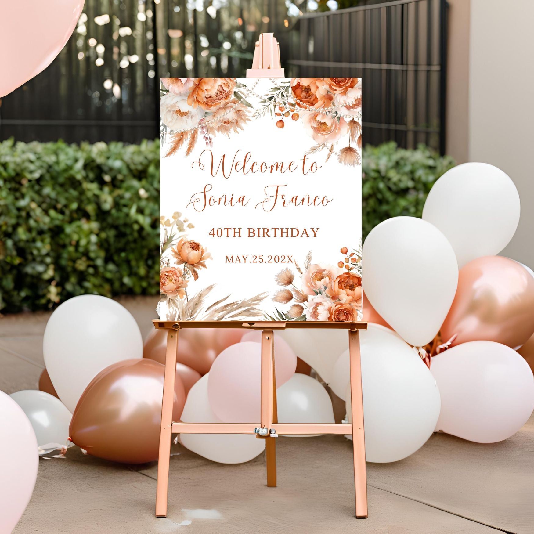 Decorative sign with floral design and balloons for a birthday celebration.