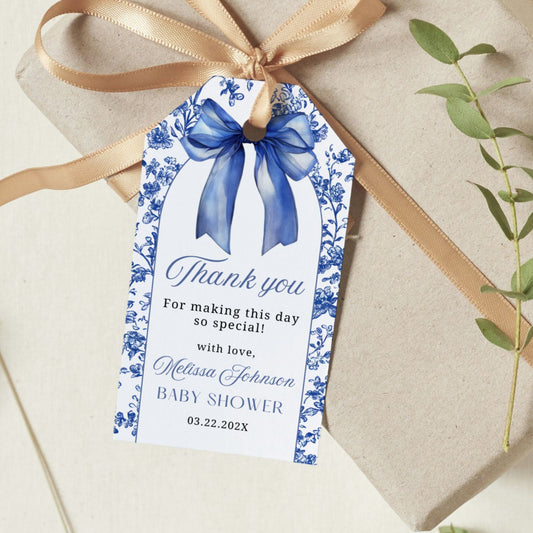 Baby shower thank you tag with blue Bow ribbon on a gift box