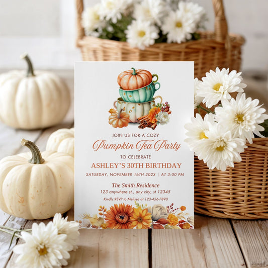 Editable Invitation card for a Pumpkin Tea Party birthday celebration with pumpkins and flowers on a wooden table.