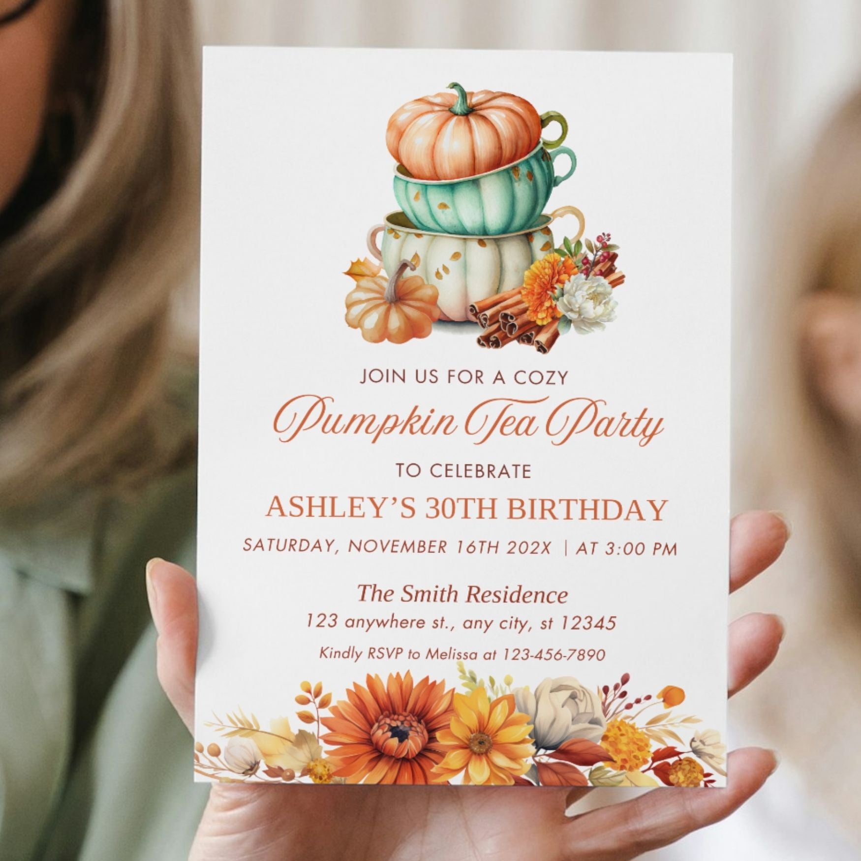 Invitation card for a pumpkin tea party birthday celebration held by a person.