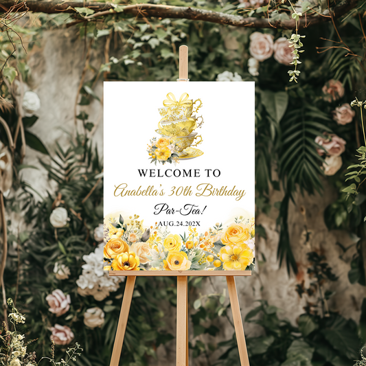 Decorative sign for a tea party birthday celebration with floral and teacup design on an easel.