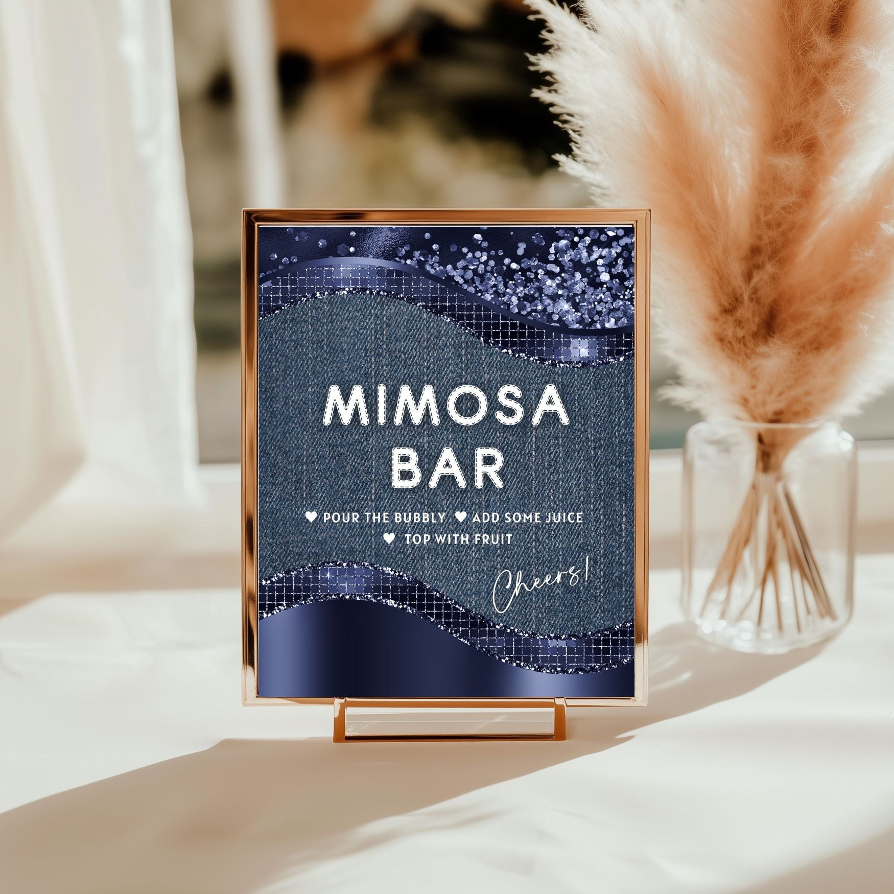 Decorative sign for a mimosa bar with a blue Denim glittery background on a stand.