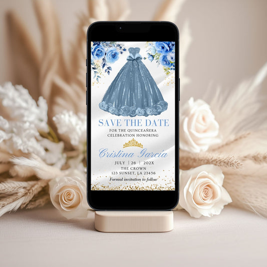 Phone displaying a Dusty blue dress and floral 'Save the Date' invitation with flowers and decor in the background.