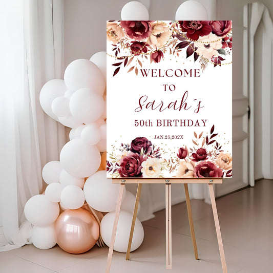Burgundy Floral welcome sign for a birthday party with balloons in the background