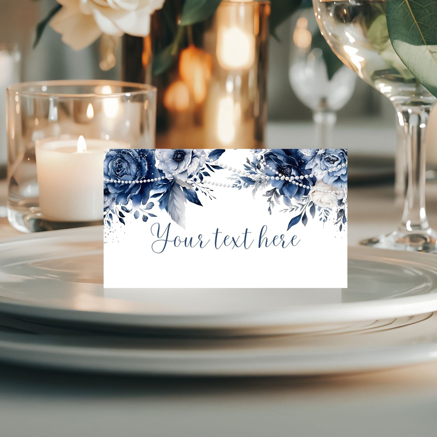 Place card with Blue floral design on a table setting with candles and glasses.