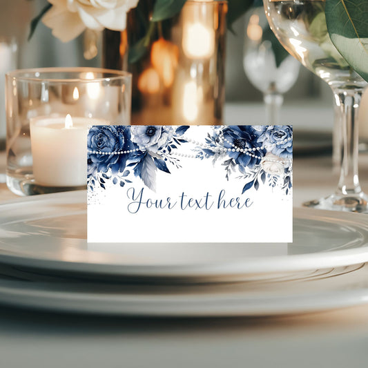 Place card with Blue floral design on a table setting with candles and glasses.