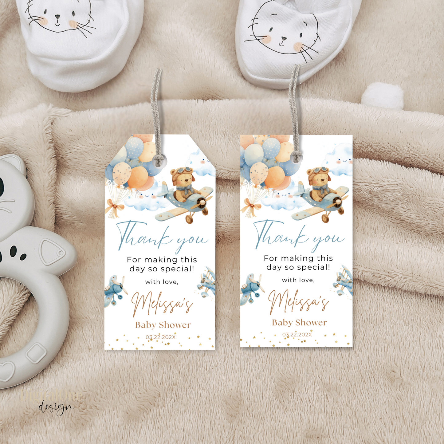 Two baby shower thank you tags with teddy bear and balloon design on a soft fabric background.