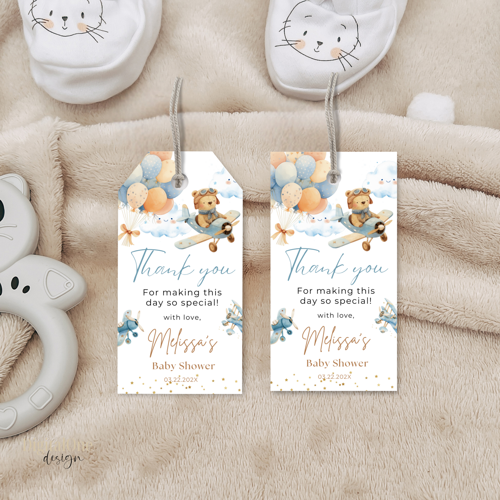 Two baby shower thank you tags with teddy bear and balloon design on a soft fabric background.
