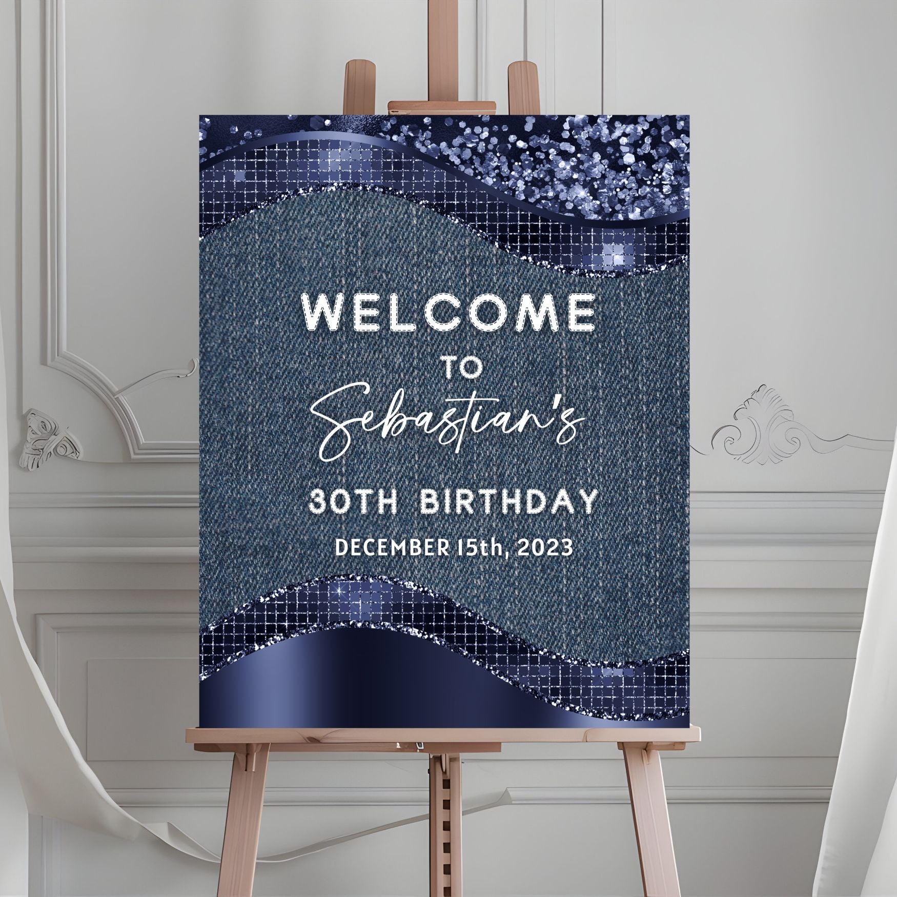 Birthday welcome sign on an easel with a blue and silver design.