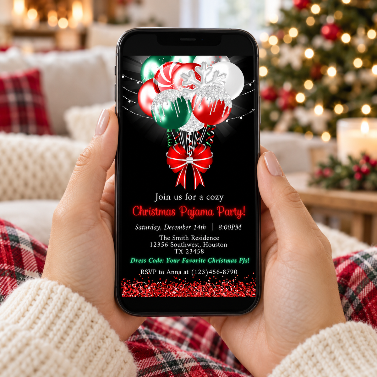 Christmas Pajama Party Invitation with Candy Cane Balloons displayed on a smartphone surrounded by holiday decor.