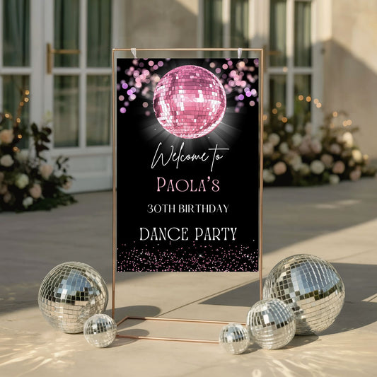 Decorative Pink sign for a birthday dance party with disco balls on a patio.