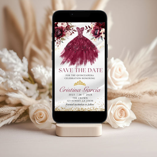Phone displaying a save the date invitation for a quinceañera with Burgundy floral and dress design, surrounded by flowers.