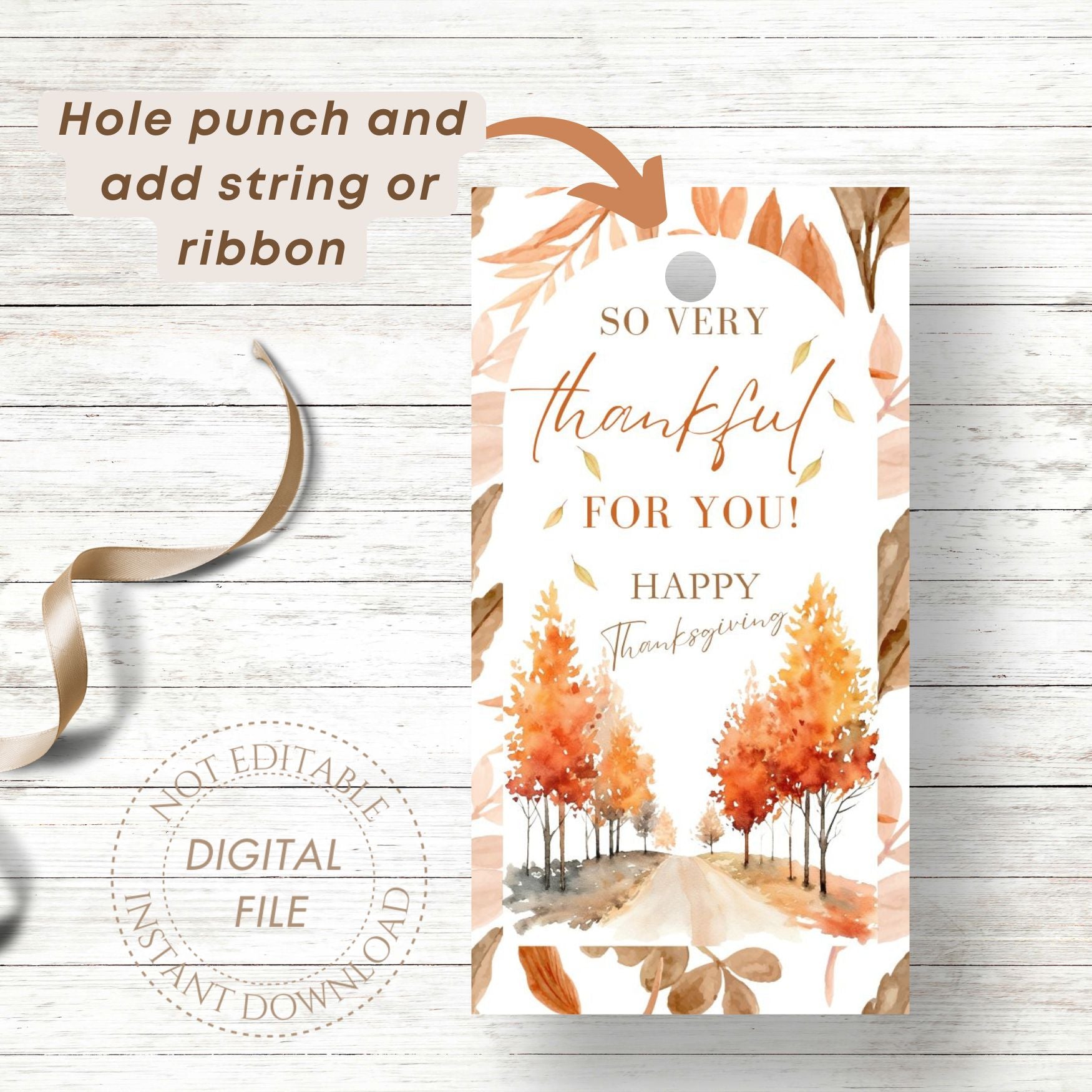 Thanksgiving-themed gift tag with autumn trees and text on a wooden surface.