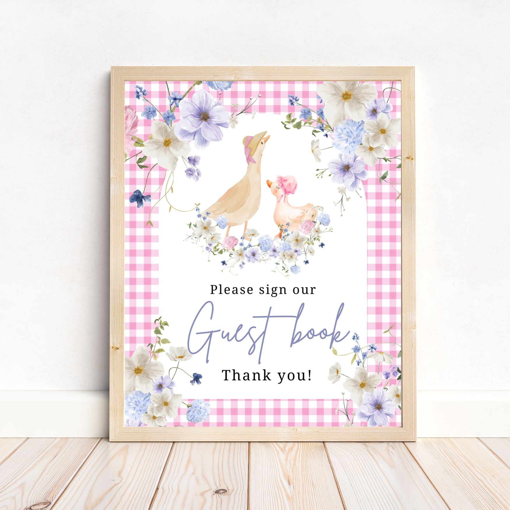Framed guest book sign with ducks and flowers on a pink checkered background