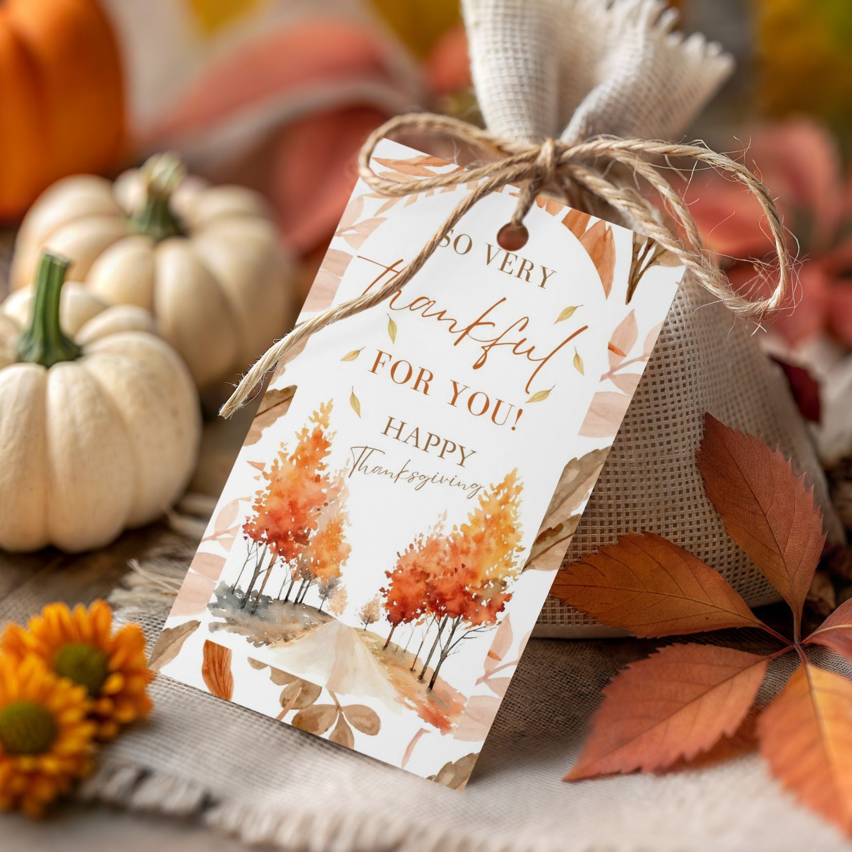 Thanksgiving gift tag with pumpkins and leaves on a wooden surface