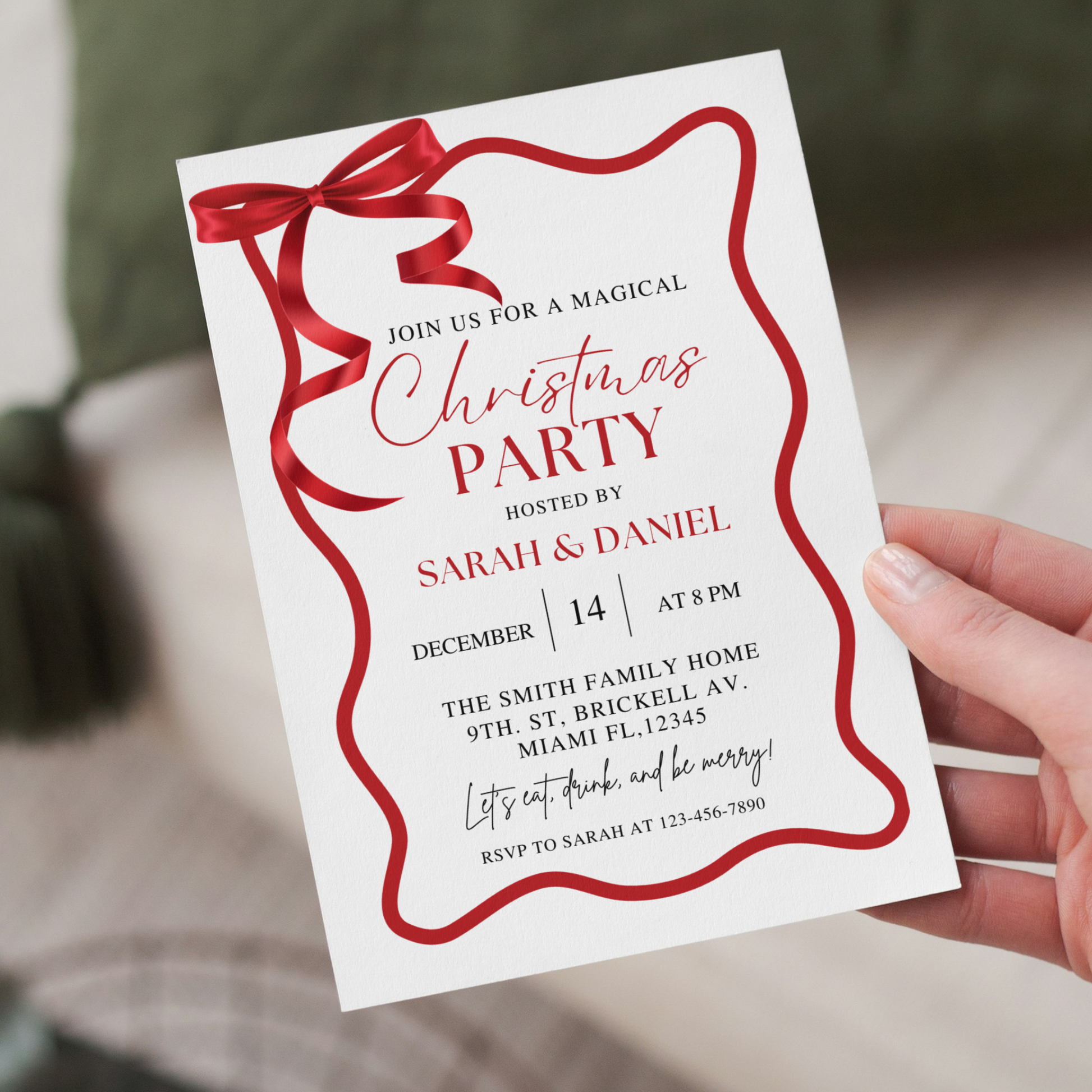 Christmas party invitation with red ribbon held by a hand